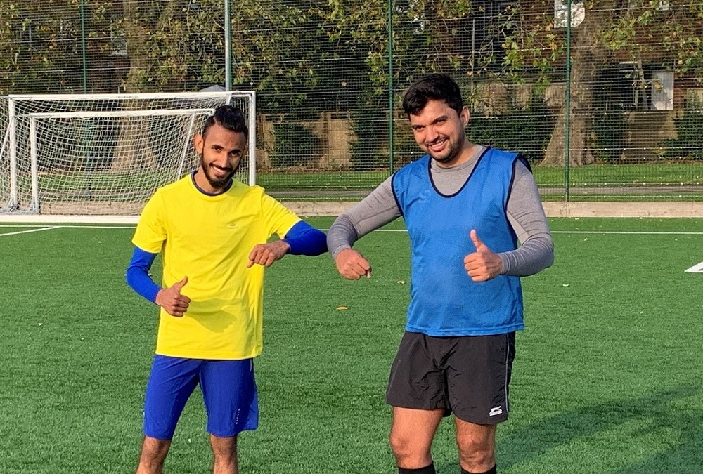 New handshake. Two footballers bumping elbows