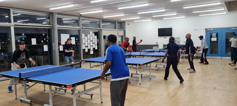 Adults playing table tennis