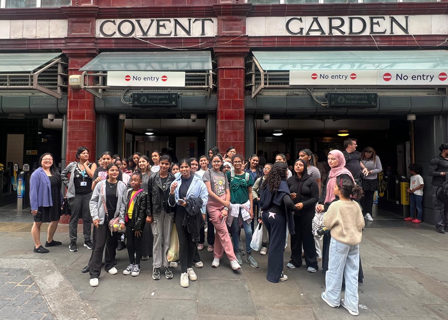 Group of girls standing outside Covent Garden station